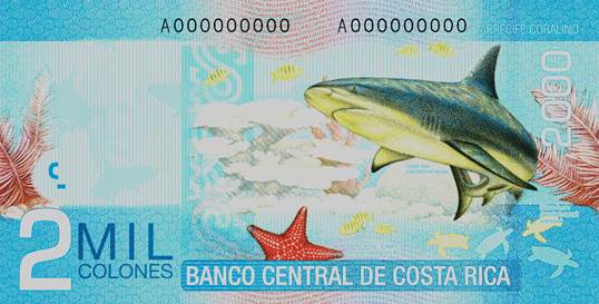 Billete decolorado de 2.000 colones con ilustraciones de fauna marina, incluyendo un manatí, peces y una estrella de mar, sobre un fondo en tonos azules.
