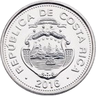 Reverso de una moneda plateada de 10 colones del Banco Central de Costa Rica. En la parte superior se observa el número "10", seguido de la palabra "COLONES". En la sección inferior aparece el acrónimo "B.C.C.R.", acompañado por dos ramas de laurel que se extienden hacia los lados sobre un diseño de líneas horizontales en relieve. La moneda tiene forma circular, acabado plateado y borde decorado con puntos.