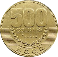 Reverso de una moneda dorada de 500 colones del Banco Central de Costa Rica. En la parte superior destaca el número "500", seguido de la palabra "COLONES". Debajo se observan dos ramas de laurel en relieve y un conjunto de puntos decorativos sobre un fondo de líneas horizontales. En la parte inferior aparece el acrónimo "B.C.C.R.". La moneda presenta un acabado metálico dorado, forma circular y borde decorado con pequeñas marcas alrededor de todo el contorno.