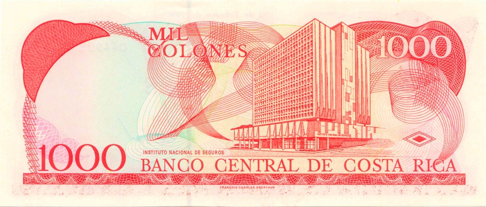Reverso del billete de ₡1.000 de Costa Rica con la imagen del edificio del Instituto Nacional de Seguros y la denominación del valor facial.